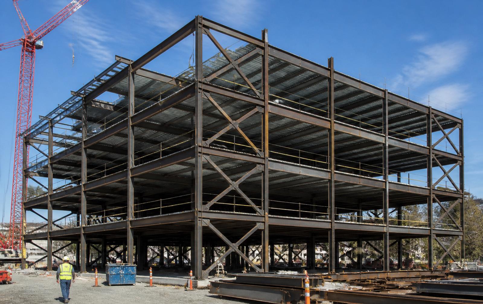 Erected structural steel frame with X-bracing on perimeter bays during construction